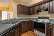 Thumbnail 12 of 22 - Kitchen with hardwood style flooring, double basin sink, and dark espresso cabinetry