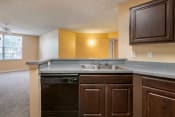 Thumbnail 13 of 22 - Kitchen breakfast bar, double basin sink, and dark espresso cabinetry