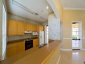 Thumbnail 14 of 26 - Community Center Kitchen with Light Wood Cabinets and Tan Counters