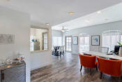 Thumbnail 6 of 24 - Clubhouse interior with hardwood style flooring, white walls, and two leather accent chairs