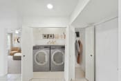 Thumbnail 30 of 30 - a small laundry room with a washer and dryer