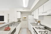 Thumbnail 11 of 28 - a kitchen with white cabinets and white appliances