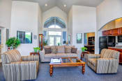 Thumbnail 9 of 21 - Leasing office seating area with couches and chairs