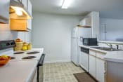 Thumbnail 18 of 21 - Model Kitchen with White Counters Cabinets and Appliances