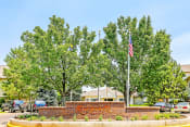 Thumbnail 1 of 25 - Community Sign on Median in Front of Trees and Flagpole