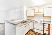Thumbnail 22 of 25 - Kitchen with White Appliances, Grey Counters and White Cabinets with Wood Accents