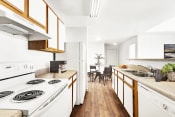 Thumbnail 17 of 28 - kitchen with white appliances and hardwood-style flooring