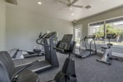 Thumbnail 17 of 24 - Fitness center with cardio machines facing 2 large windows