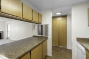 Thumbnail 13 of 19 - a kitchen with granite countertops and wooden cabinets at Willows Court Apartment Homes, Washington