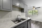 Thumbnail 19 of 30 - kitchen with Grey Cabinetry and Plank Flooring at Swiss Gables Apartment Homes, Kent