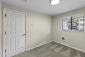 Thumbnail 5 of 30 - Living Room with a white door and a window at Swiss Gables Apartment Homes, Kent, Washington 98032