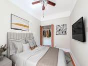 Thumbnail 6 of 38 - a bedroom with a large bed and a ceiling fan