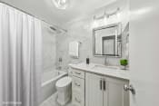 Thumbnail 15 of 62 - a white bathroom with a shower toilet and sink