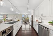 Thumbnail 8 of 62 - a large kitchen with white cabinets and stainless steel appliances