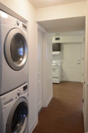 Thumbnail 11 of 15 - a washer and dryer in a laundry room