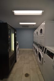 Thumbnail 5 of 15 - a row of washers and dryers in a laundry room