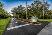 Thumbnail 2 of 24 - the welcome sign at the end of a road with flowers