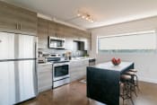Thumbnail 2 of 10 - a modern kitchen with stainless steel appliances and wooden cabinets