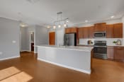 Thumbnail 39 of 39 - a kitchen with a large center island with a white countertop | Centerpointe Apartments in Camp Hill
