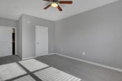 Thumbnail 38 of 39 - a bedroom with grey walls and a ceiling fan | Centerpointe Apartments in Camp Hill