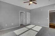 Thumbnail 35 of 39 - a bedroom with gray walls and a ceiling fan | Centerpointe Apartments in Camp Hill
