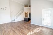 Thumbnail 19 of 21 - an empty living room with wood floors and a staircase