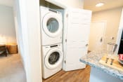 Thumbnail 14 of 21 - a washer and dryer in a laundry room