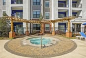 Thumbnail 3 of 26 - hot tub area and apartment building on sunny day  at The Brookhaven Collection, Atlanta