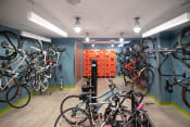 Thumbnail 20 of 41 - a room with many bikes on the wall and a wall of orange boxes