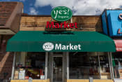 Thumbnail 20 of 23 - the front of a yes market store with a green awning