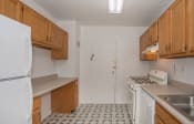 Thumbnail 19 of 22 - a kitchen with white appliances and wooden cabinets and a white refrigerator
