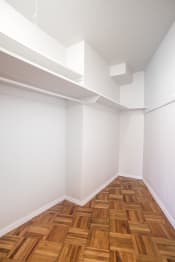 Thumbnail 17 of 22 - a white room with wooden floors and white walls