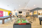 Thumbnail 6 of 20 - a recreation room with a foosball table and ping pong table