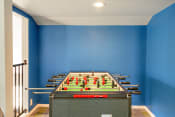 Thumbnail 10 of 27 - a foosball table in a blue room with a blue wall