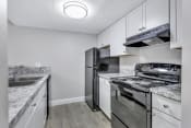 Thumbnail 1 of 35 - a kitchen with stainless steel appliances and white cabinets