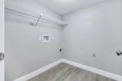 Thumbnail 13 of 35 - an empty room with white walls and wood flooring and a wire shelf on top