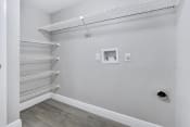 Thumbnail 12 of 35 - a room with white walls and a white closet with shelves