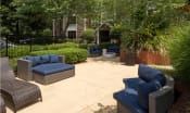 Thumbnail 6 of 17 - a patio with couches and chairs in a garden