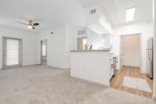 Thumbnail 15 of 43 - an empty living room and kitchen with white walls and wood flooring