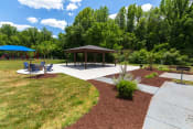 Thumbnail 13 of 20 - a picnic area with benches and a pavilion in the middle of a grassy area