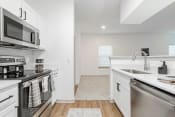 Thumbnail 21 of 43 - a renovated kitchen with stainless steel appliances and white cabinets