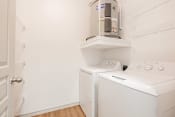 Thumbnail 18 of 43 - a laundry room with a washer and dryer and a coffeemaker in