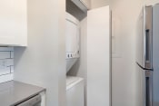 Thumbnail 4 of 11 - a laundry room with a washer and dryer