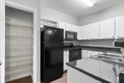 Thumbnail 6 of 28 - the preserve at ballantyne commons apartment kitchen with black refrigerator
