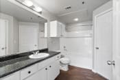 Thumbnail 10 of 28 - a bathroom with white cabinets and a sink and a toilet