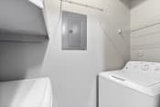 Thumbnail 13 of 28 - a white laundry room with a white washer and dryer and a white sink