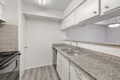 Thumbnail 21 of 37 - the kitchen has granite counter tops and a stainless steel sink