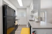 Thumbnail 3 of 37 - a kitchen with a black refrigerator and a white counter top