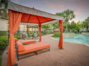 Thumbnail 15 of 21 - a poolside gazebo with orange curtains and a pool in the background