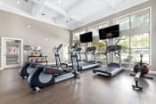 Thumbnail 17 of 26 - a gym with treadmills and other exercise equipment